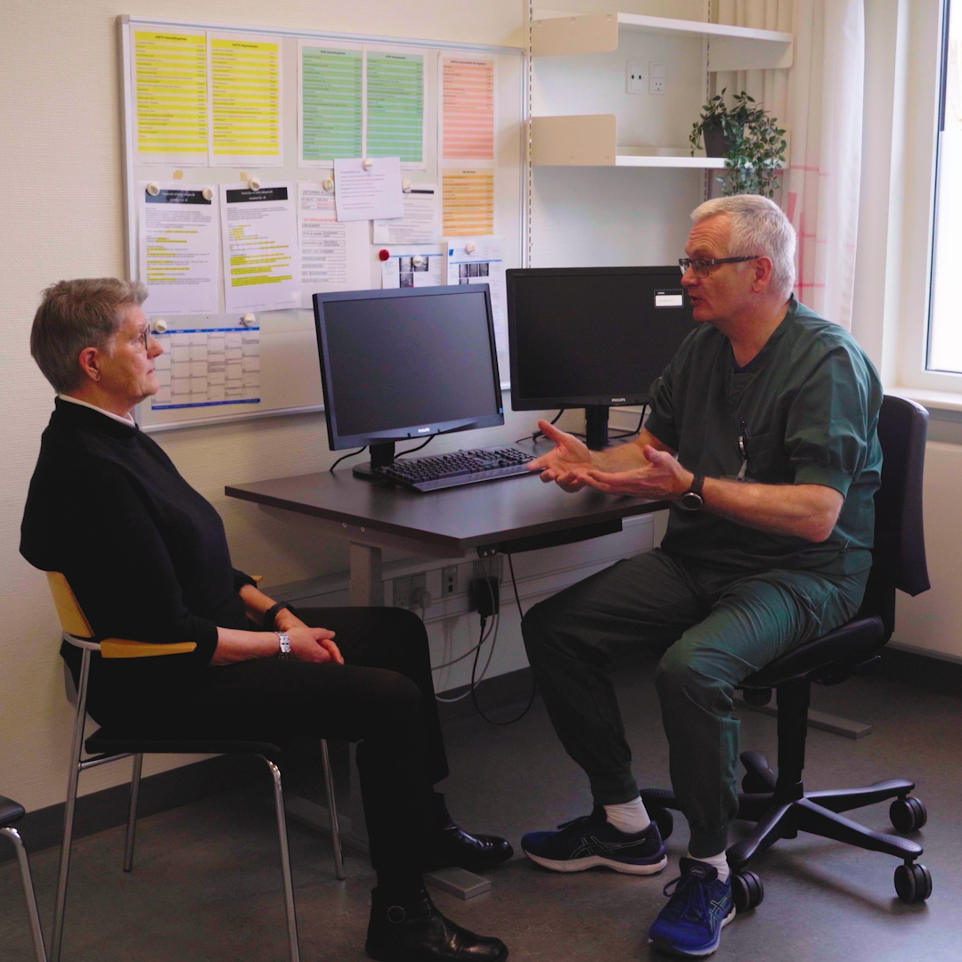 Clinician examining a patient during a consultation
